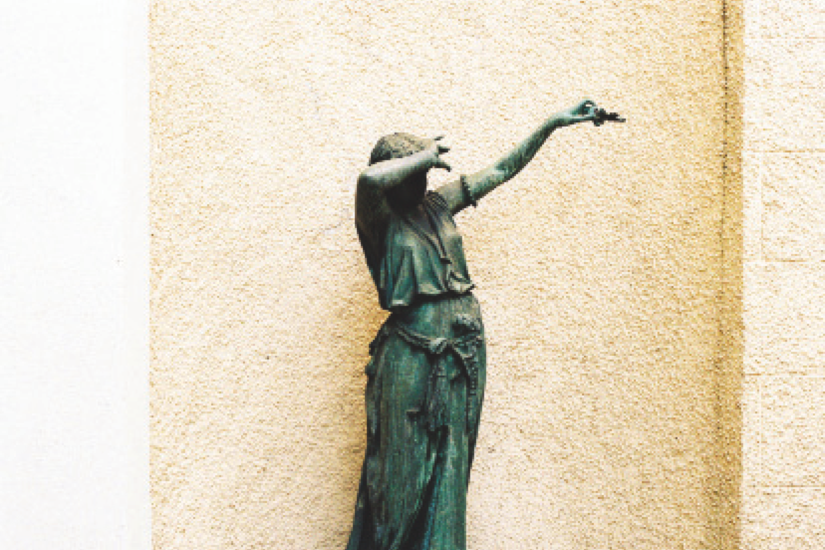 Statue covering its face with its arms