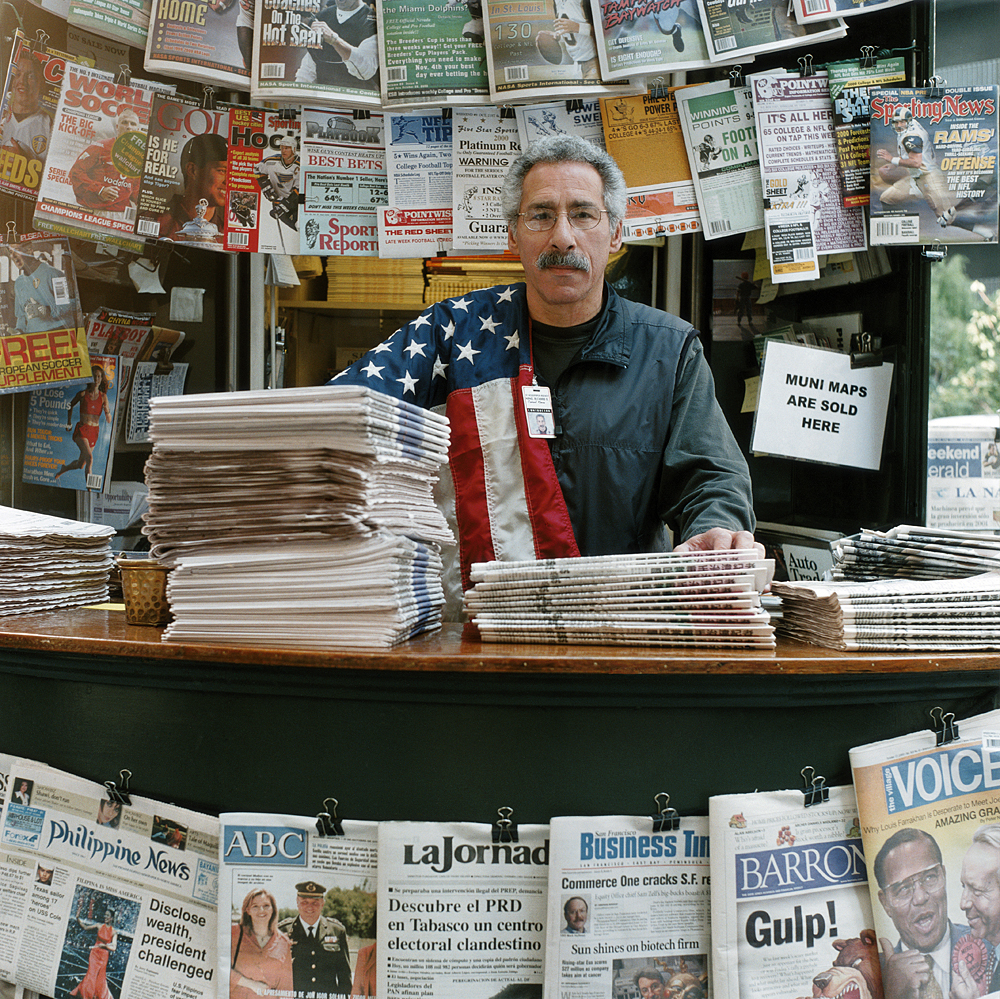 man selling newspapers
