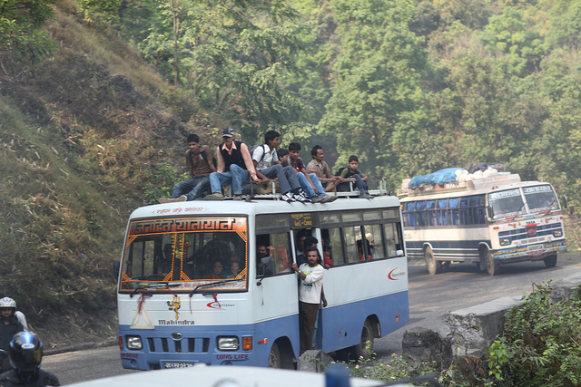 people on top of a bus