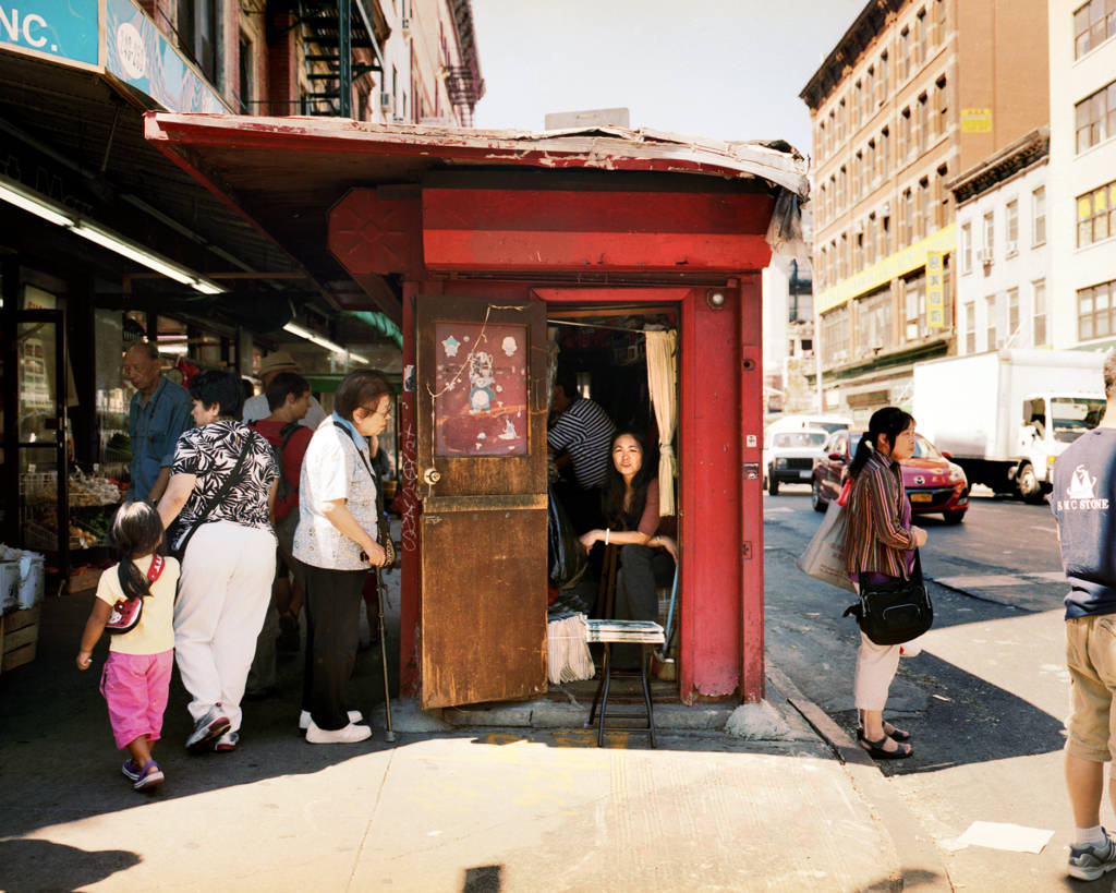 woman sitting in a newsstand