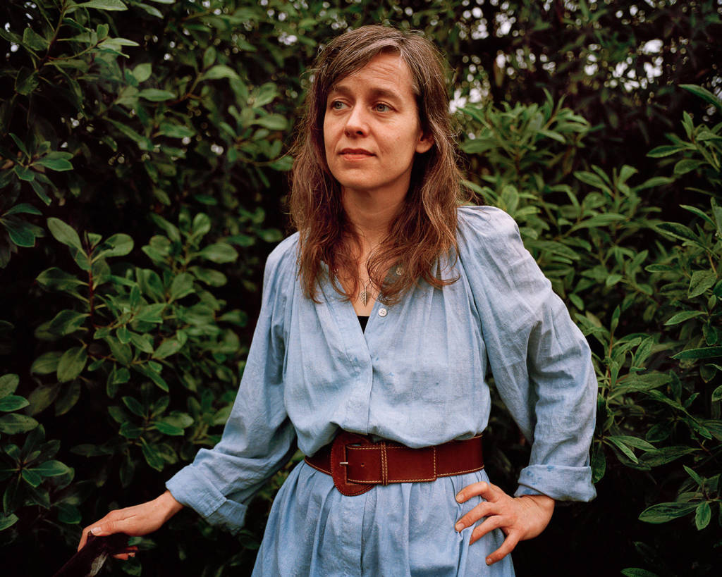 woman standing by leaves