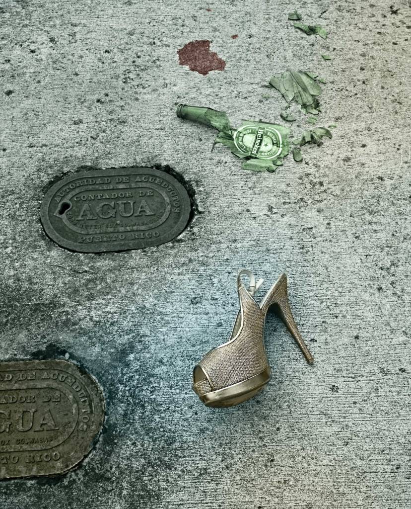Shoe and a broken glass on sidewalk