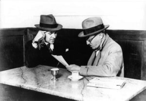 Image of two men sitting in a cafe.