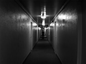 Image of a figure down the hallway.