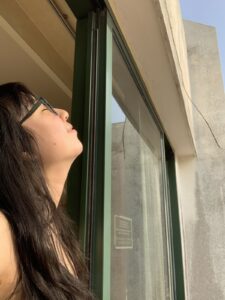 Image of woman looking out of the window.