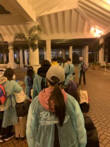 Image of people lined up in front of a hotel.