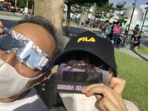 Image of people watching the eclipse through special glasses.