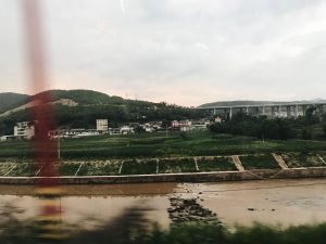 Image of a river and houses on a hill.