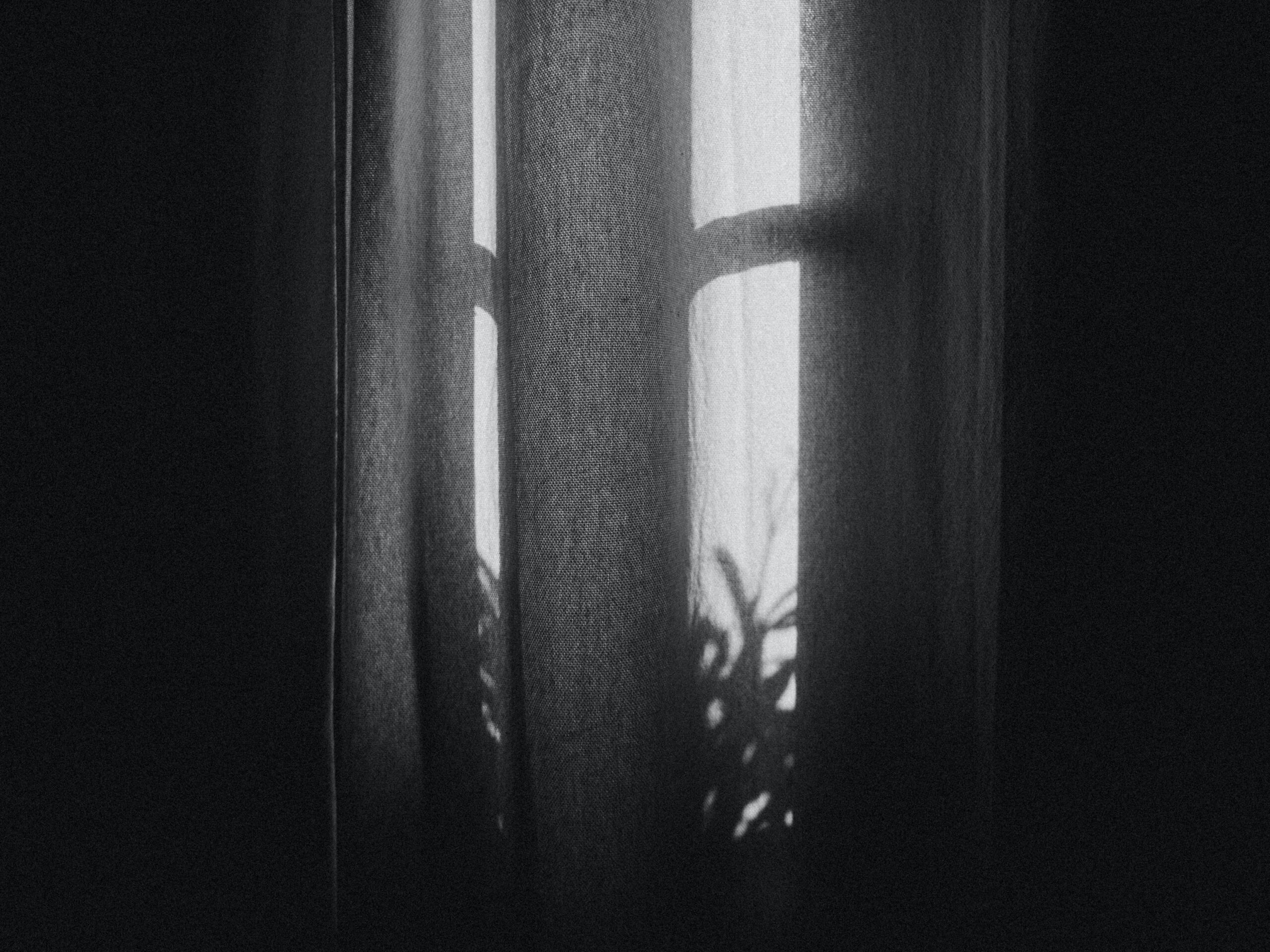 black and white curtain with light coming through