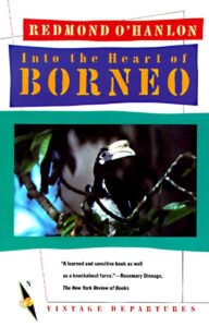 Image of the book cover of Redmond O'Hanlon's Into the Heart of Borneo (photo of a bird sitting in a tree with a turquoise outline)