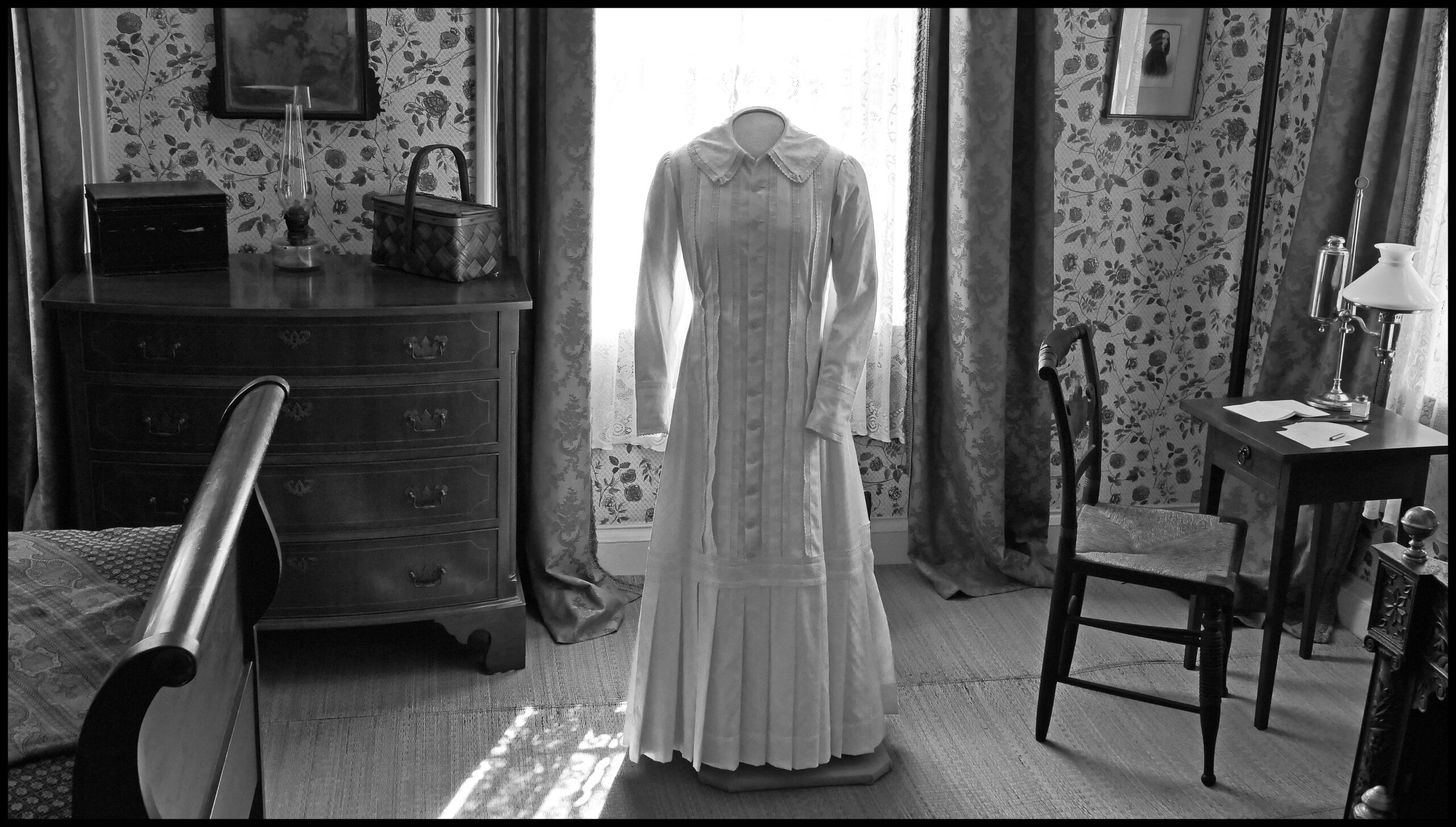 Image of Emily Dickinson's white dress displayed in her bedroom