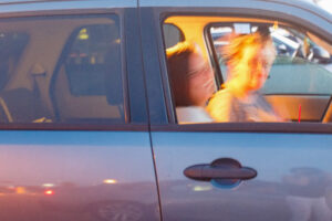 Blurry photo of a woman and a girl sitting in a car.