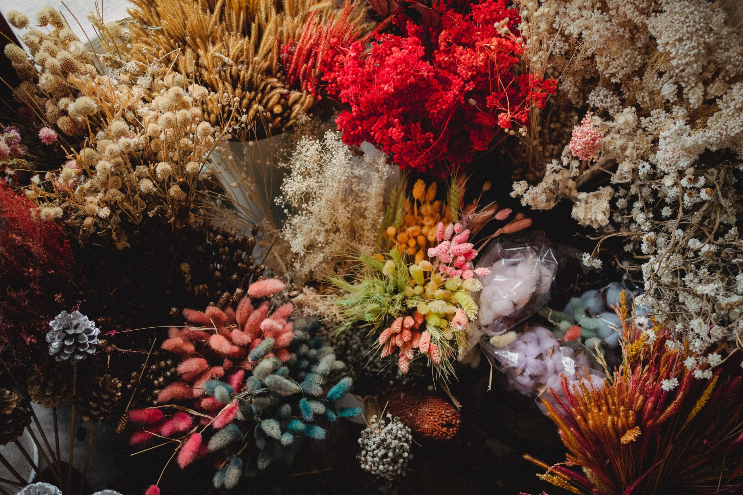 Top-down view of bouquets of various flowers, presumably for sale at a market.