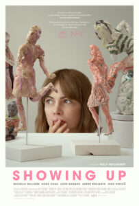 The cover of Showing Up: A White, brunette woman behind two small, anthropomorphic sculptures.