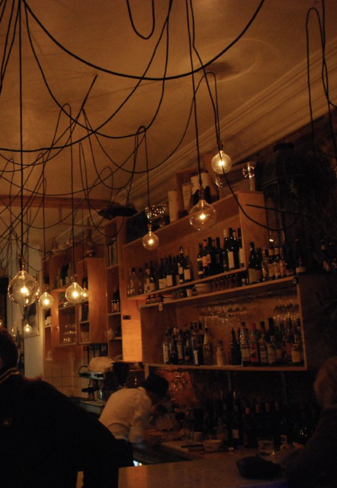 Bottles on a wall in a bar at night