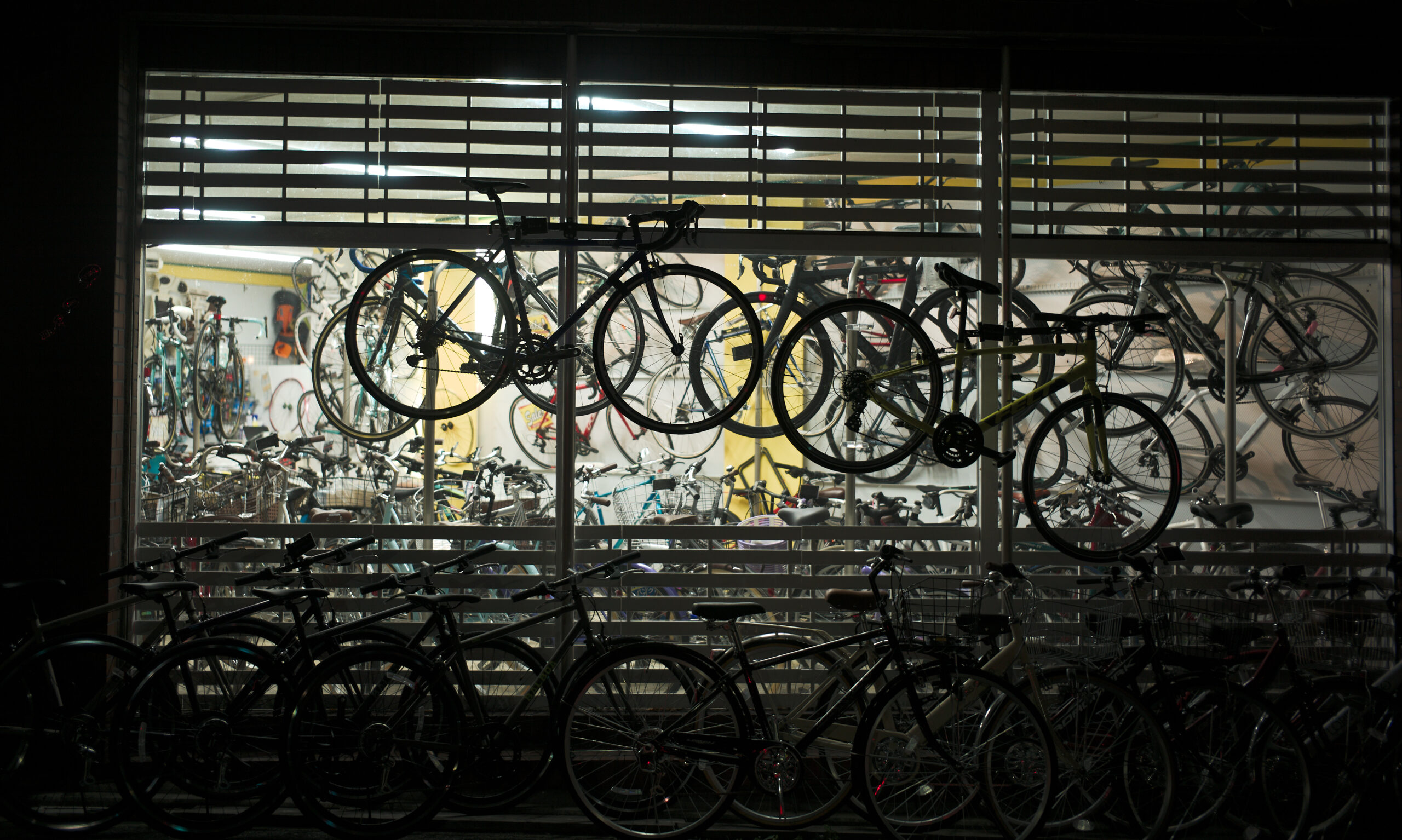 Image of the outside of a bicycle shop at night