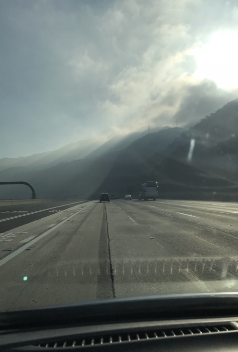 image of the hazy road with the sun shining down. POV, windshield of a car