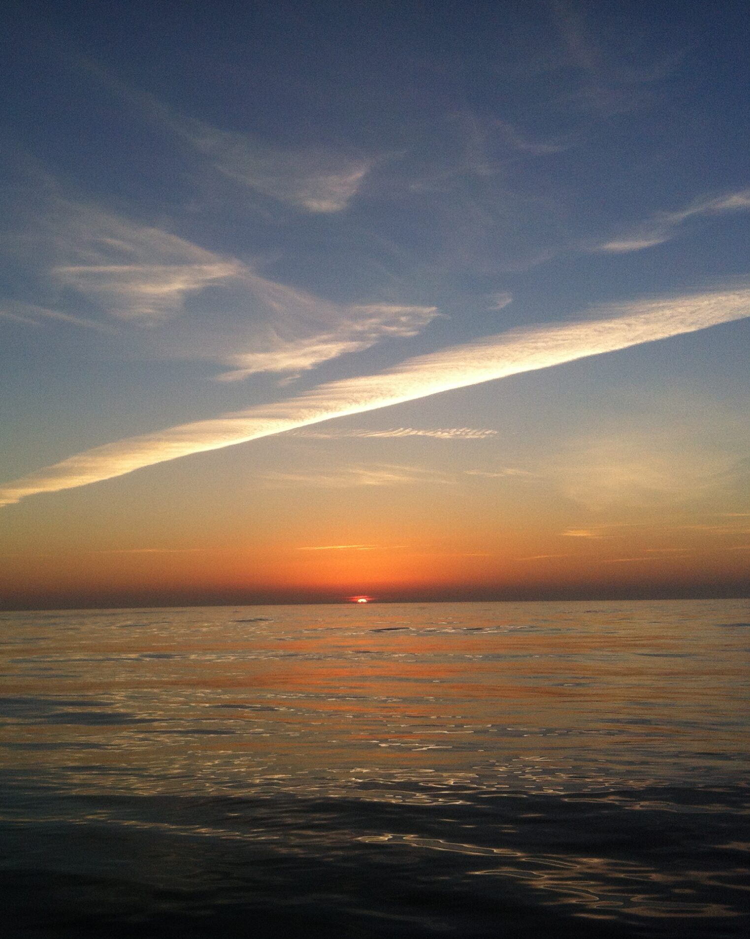 vertical image of an ocean with a sunset