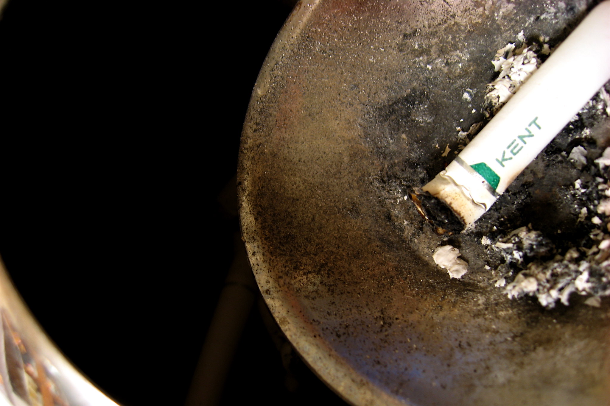 half burned cigarette on an ashtray