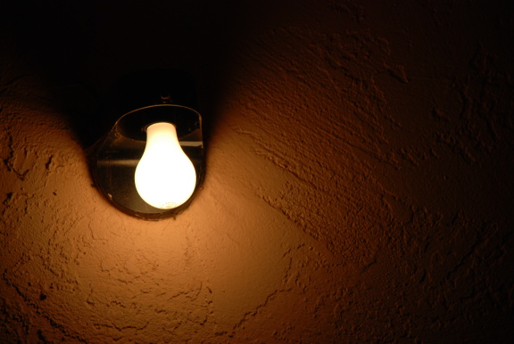 A bar lightbulb shining in the dark.