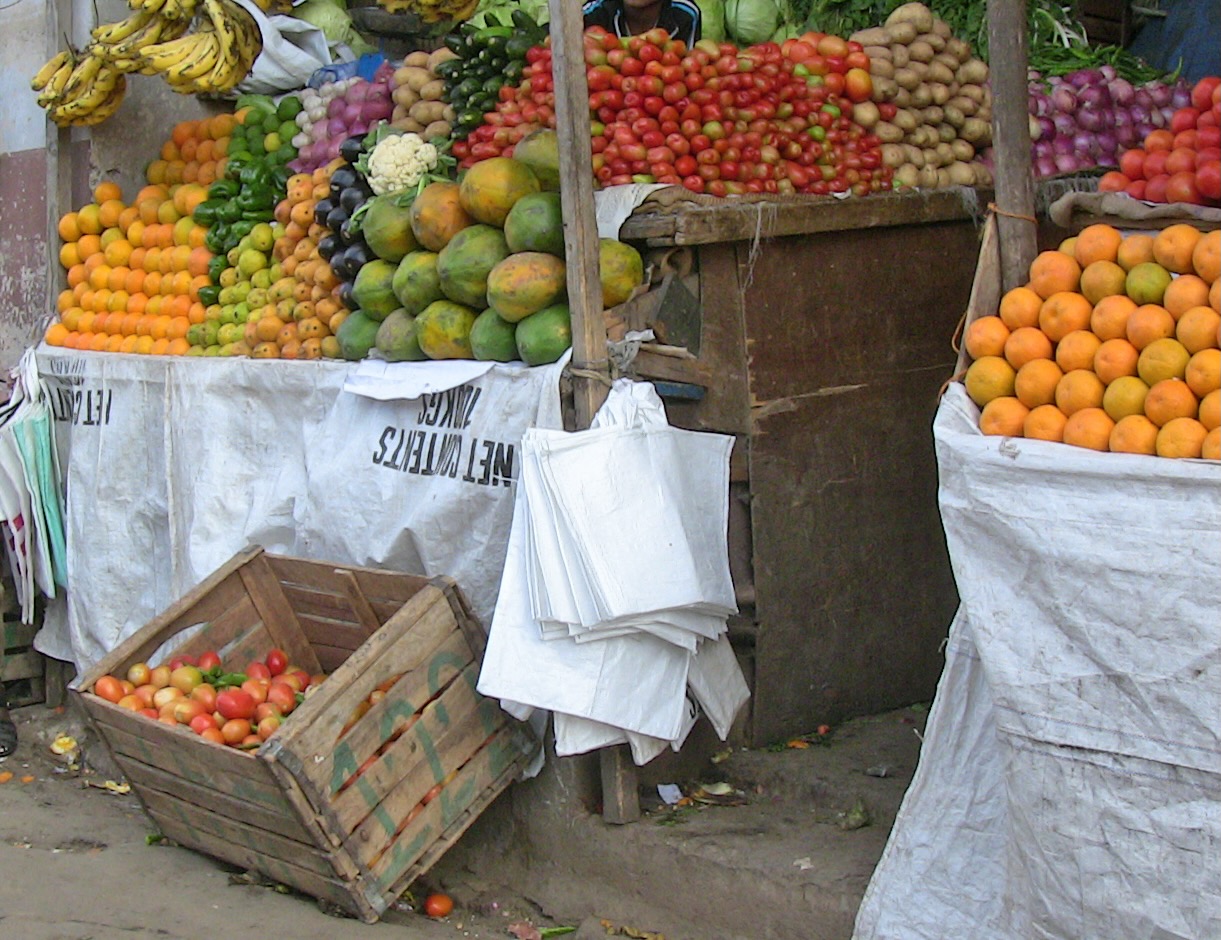 A market stall stacked with fruit of all colors.