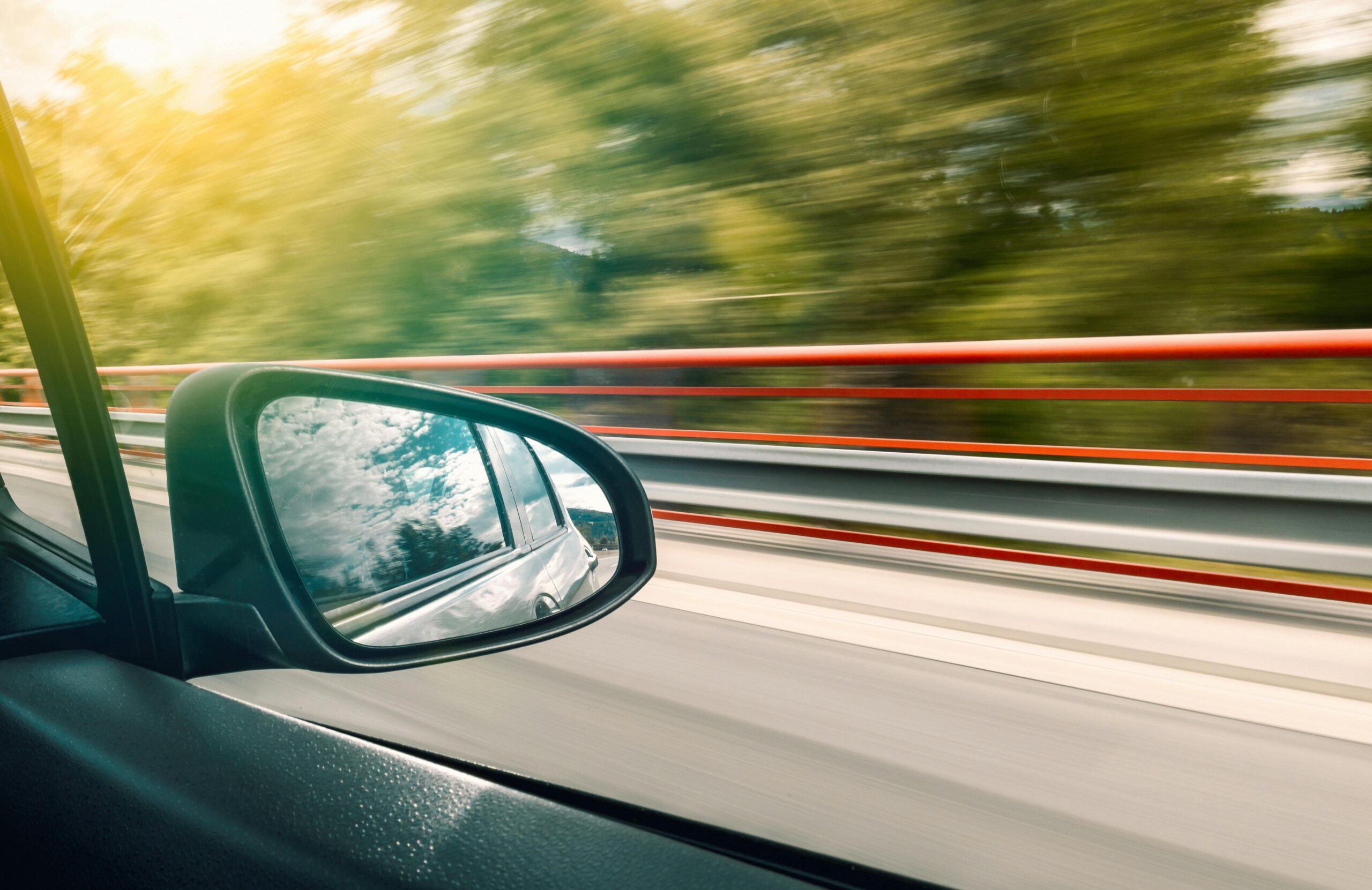 The view out of a car window as it speeds along