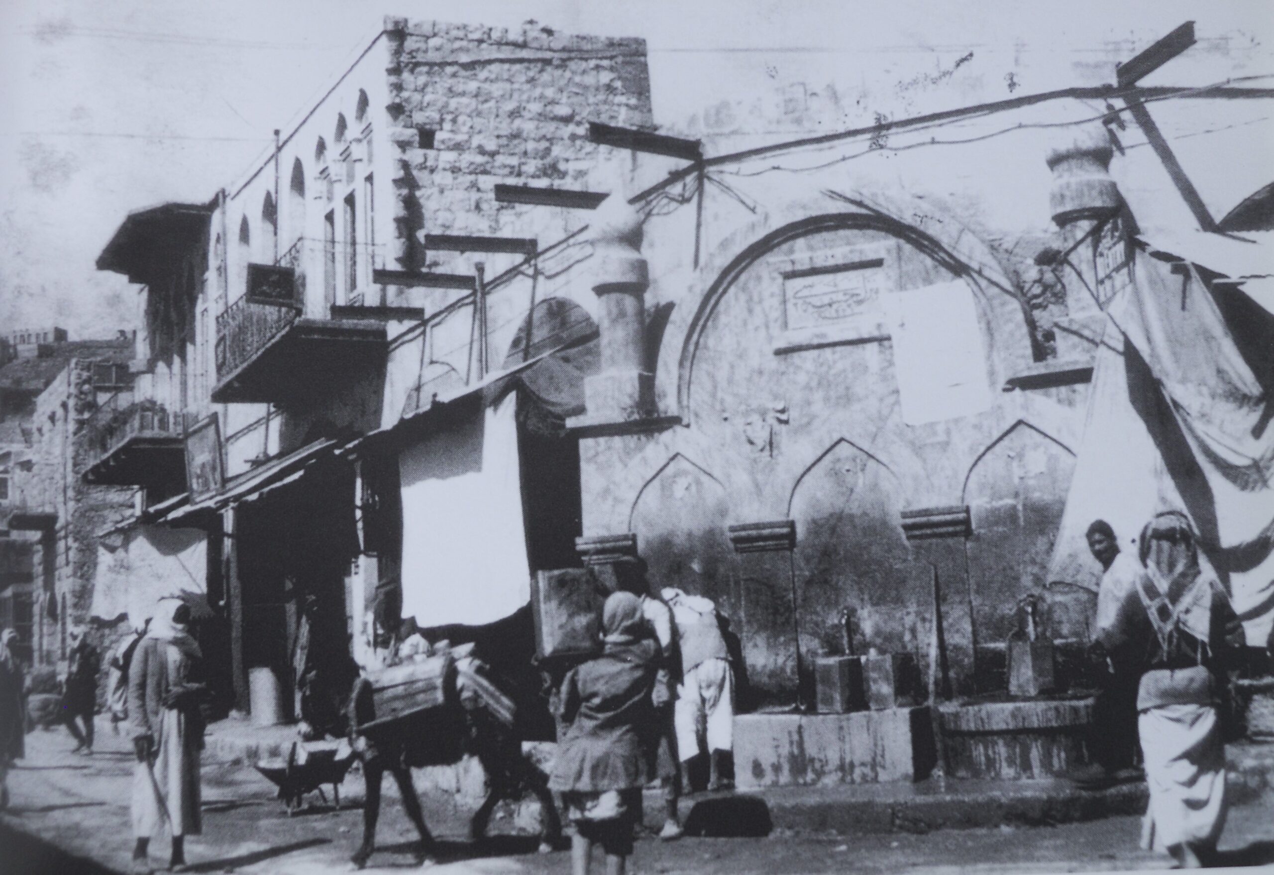 Black and white image of a building and street life