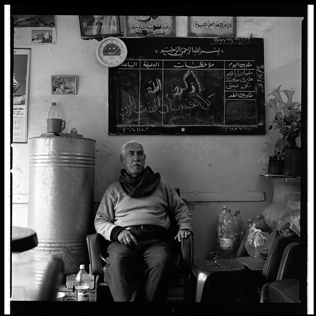 Man sits in front of a chalkboard