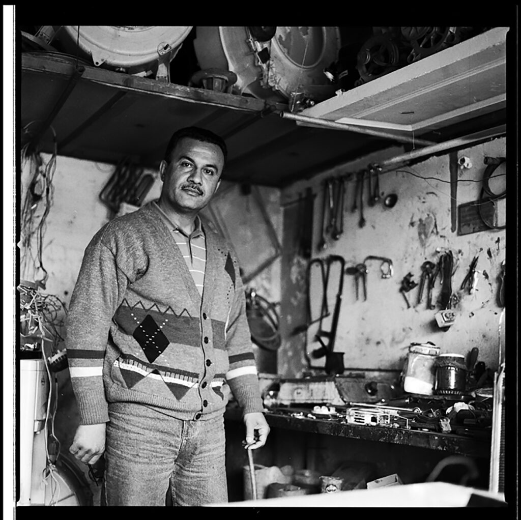 Man stands in front of a wall of tools