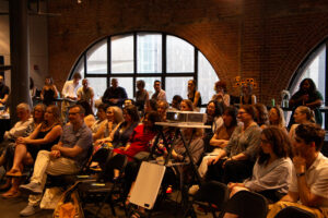 Audience members watch the panel discussion.