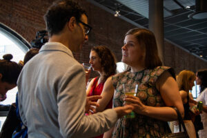 Two people having a discussion over drinks.