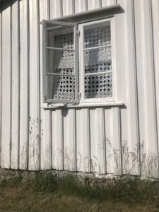 A window on the side of a white building in Temple, New Hampshire