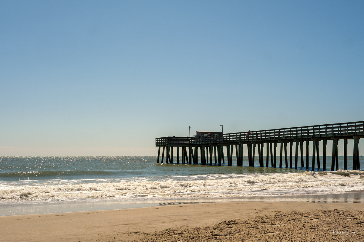 Beach with a pier in the background