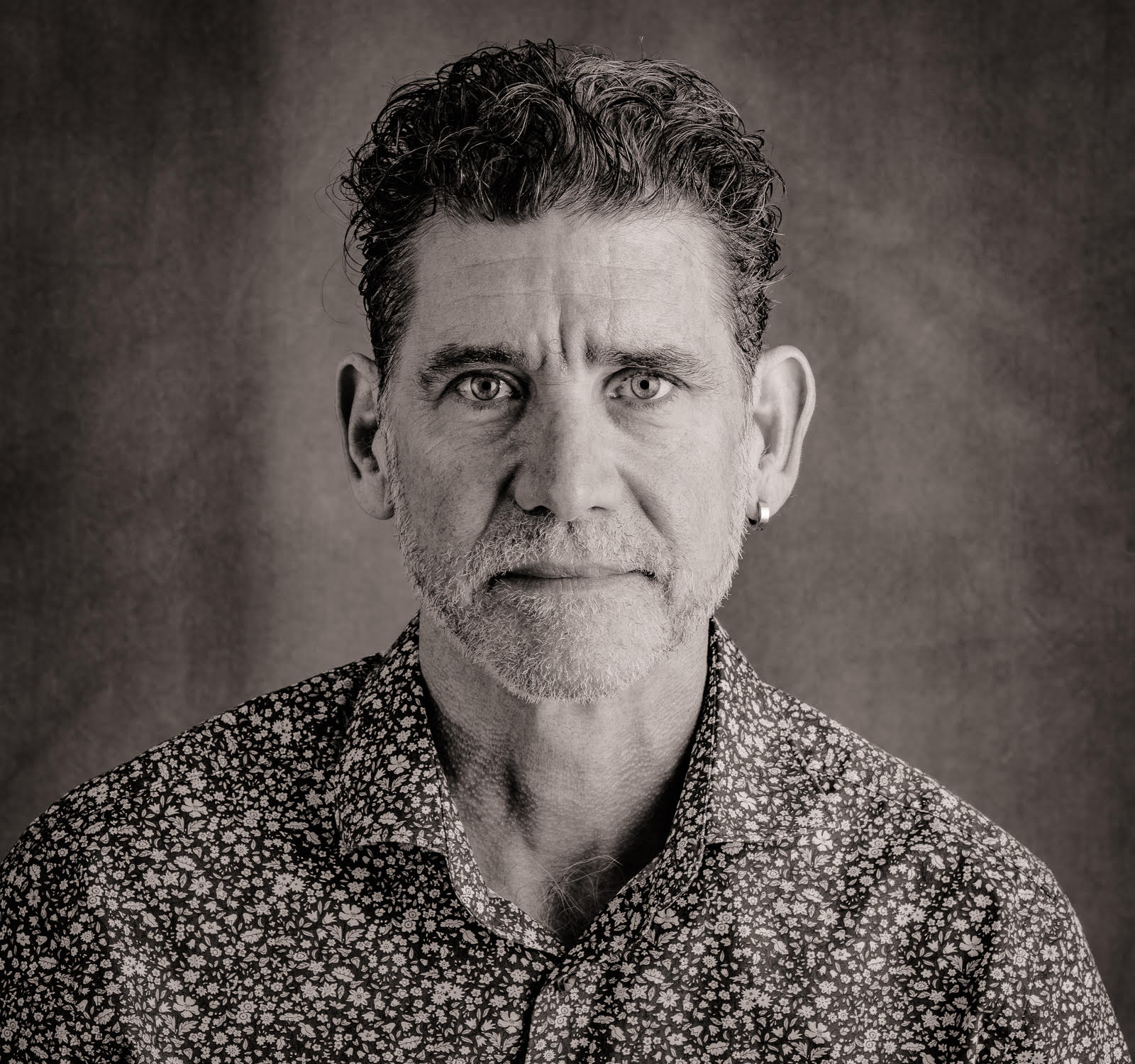 A grayscale portrait of Geoffrey Brock